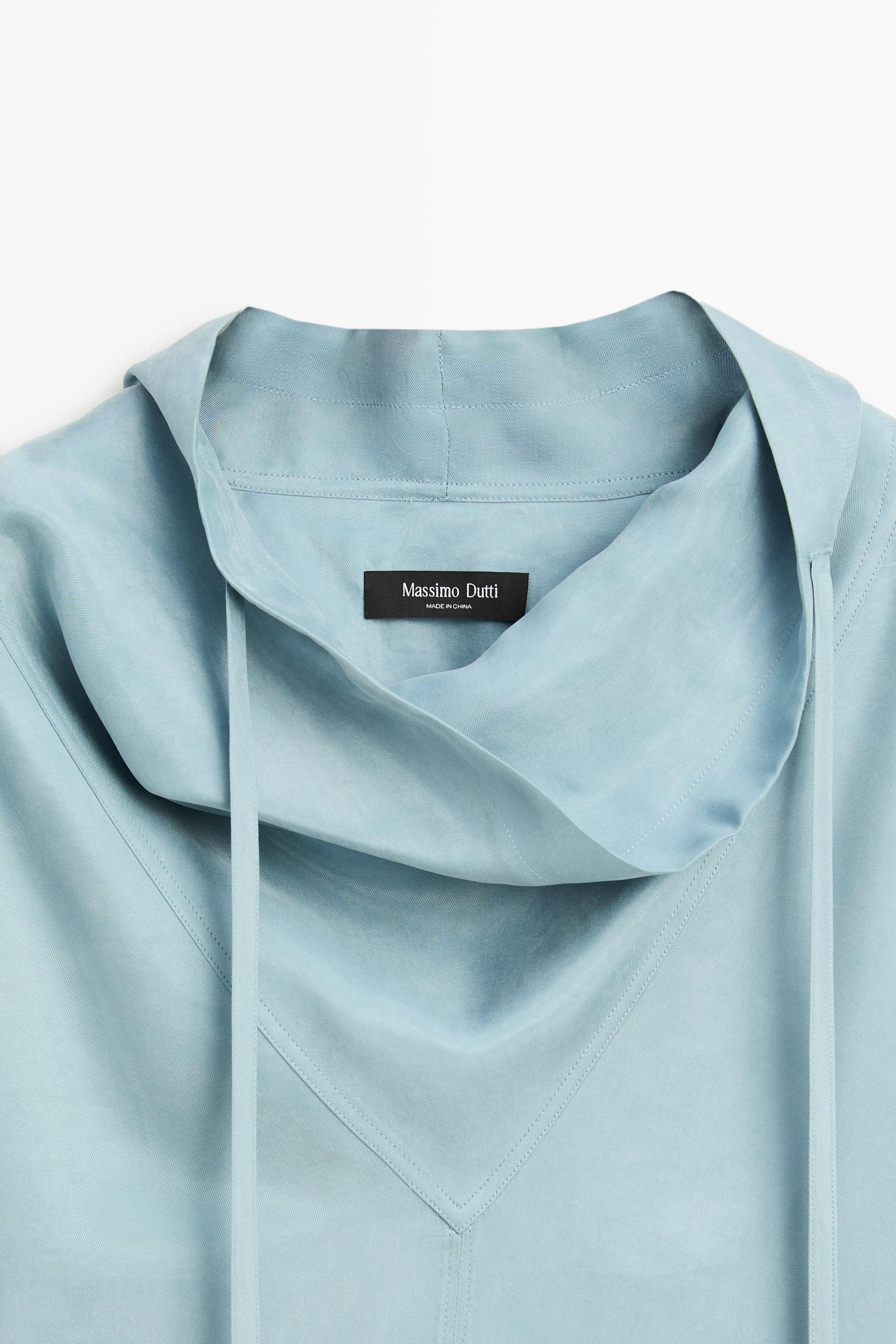 Flowing shirt with high collar and drawstring detail